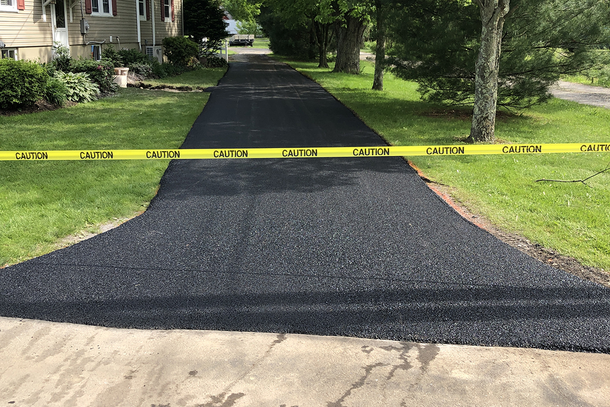 Fresh asphalt being laid on a new blacktop paving job